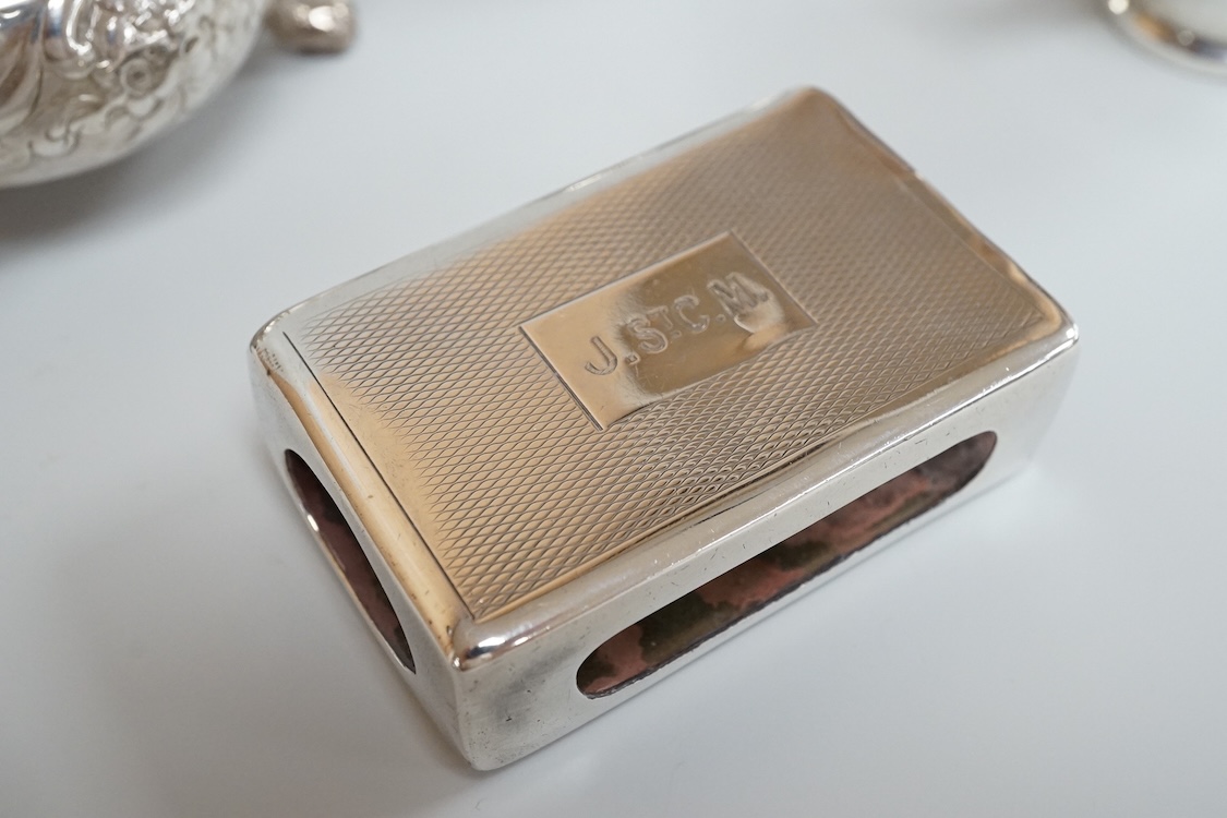 Four assorted silver condiments including a Victorian bun salt and a late Victorian pepper mill, together with a small silver bowl, a silver matchbox sleeve and a small silver two handled cup.
